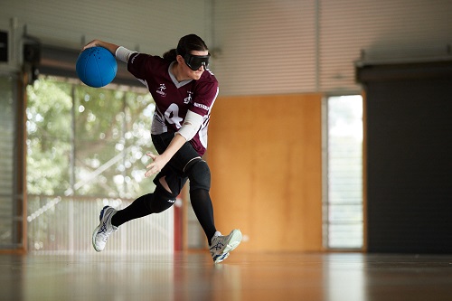 A woman playing goalball