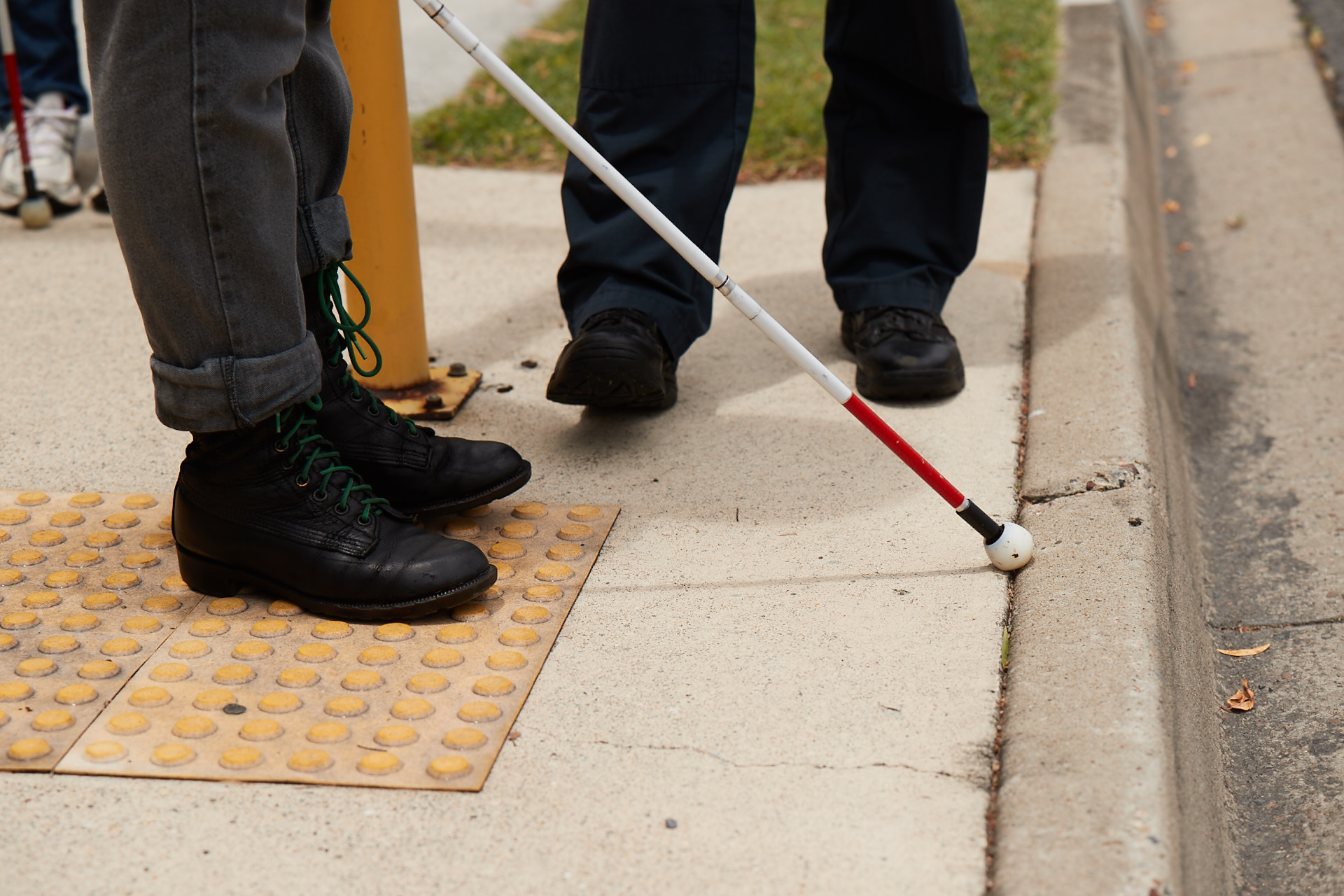 "The end of a white can touch tactile ground surface indicators"