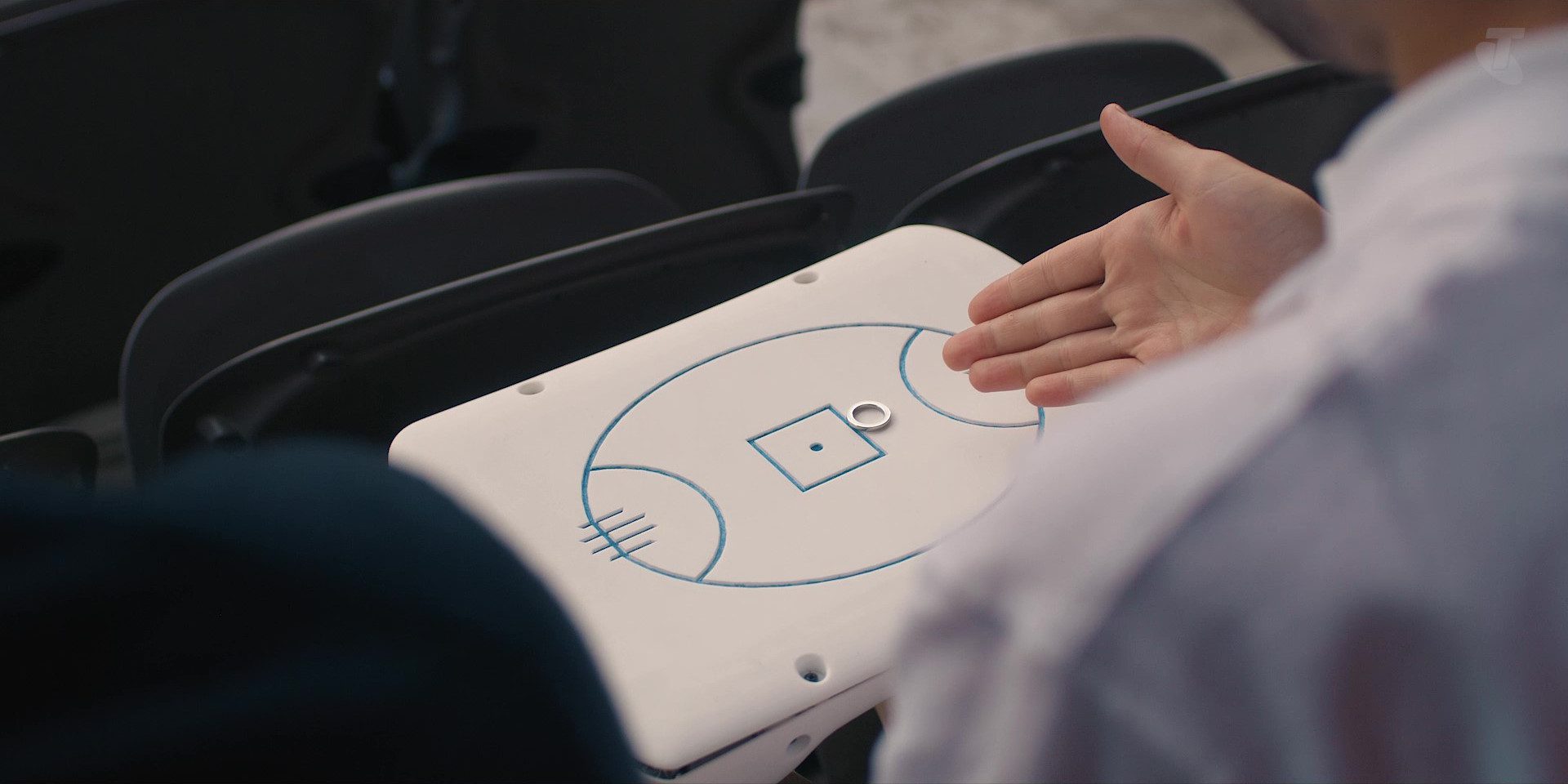 "A user holding their hand over the Touch and Track device, showing the AFL playing field."