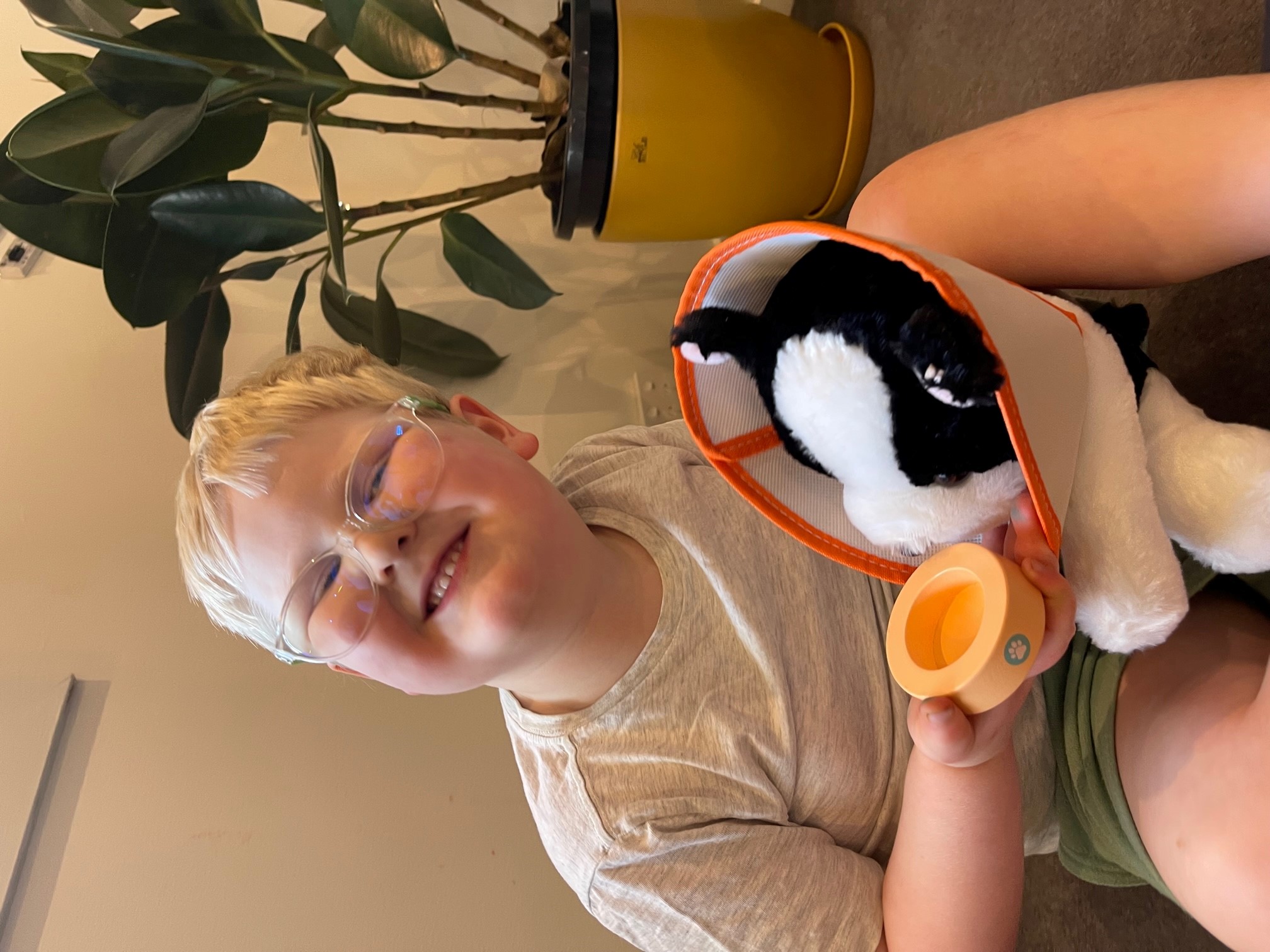 Raphael wearing glasses and holding a toy