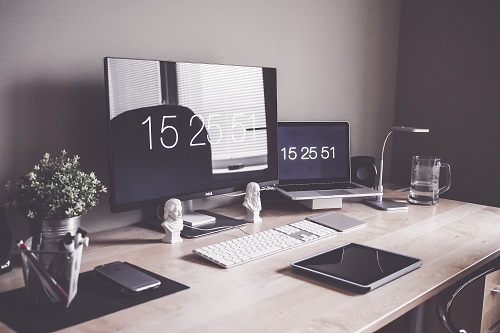 A home office set up with a computer and keyboard on a desk