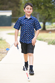 Emmanuel walking with his cane