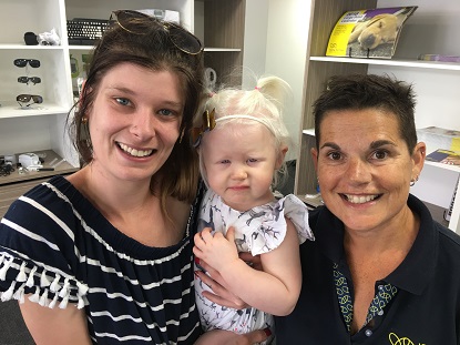 Image shows Victoria in the arms of her mother Candise and Early Childhood Development Teacher Sue Hartley.