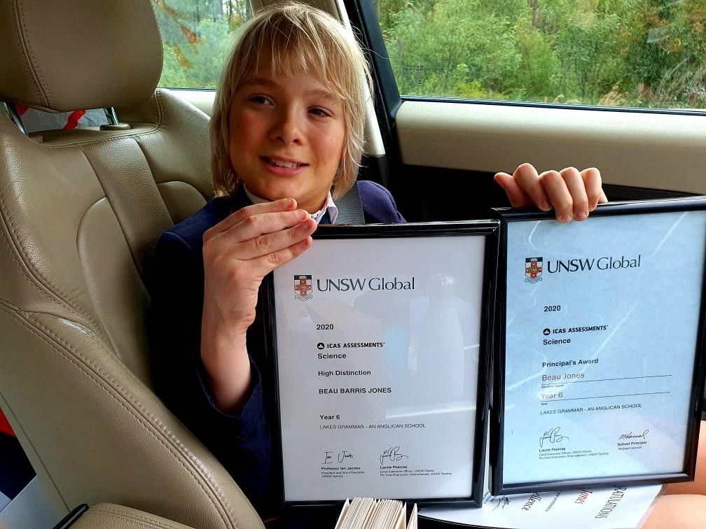 "Beau in a car, smiling with two of his awards for his Louis Braille project"