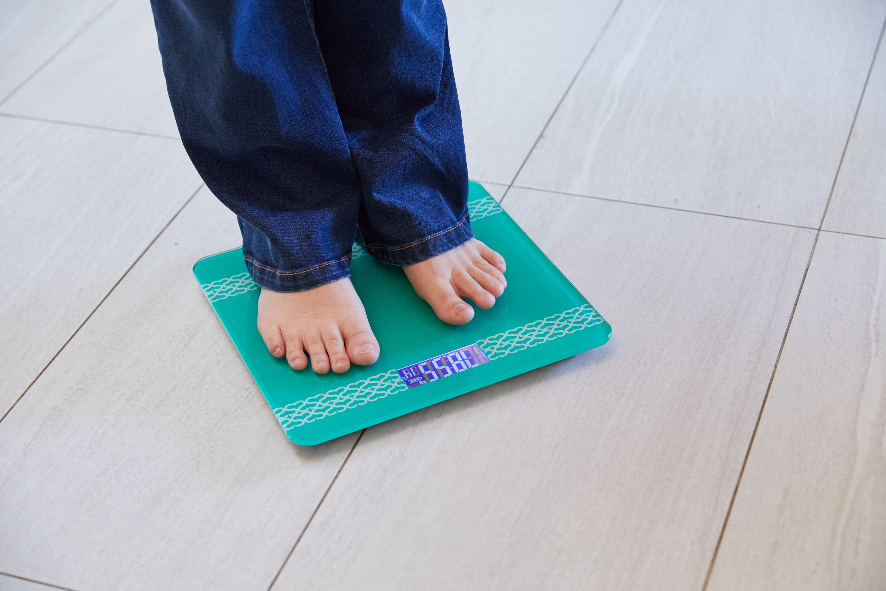 "A person standing on a set of talking scales"