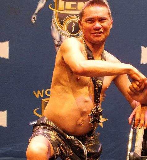 Jason Whiter poses for a photo at a body building championship. 