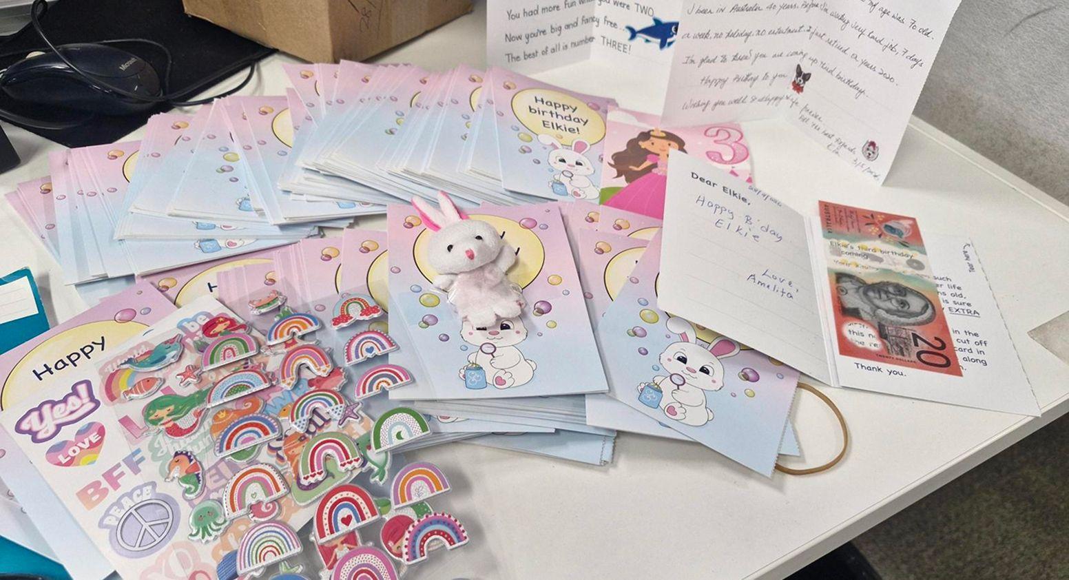A large collection of birthday cards, letters, and gifts from the donors to Elkie for her third birthday.